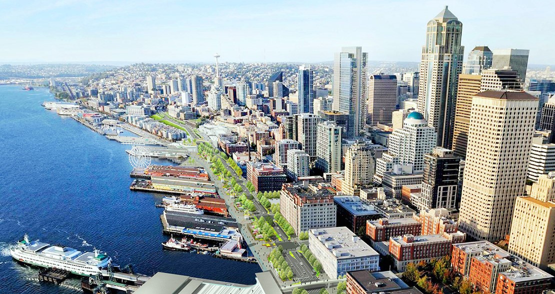 A rendering shows green space and a multimodal road spanning the Seattle waterfront with the Colman Dock ferry terminal in the foreground and the skyline in the background. 