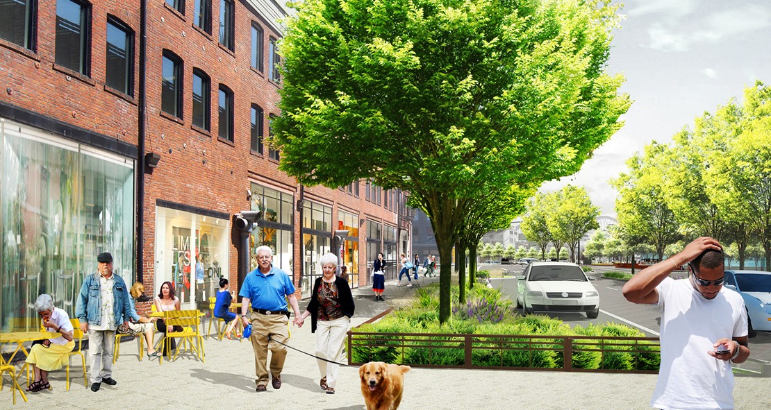 Rendering of people walking down a pedestrian sidewalk on a sunny day. Trees and shrubs protect pedestrians from the road. 